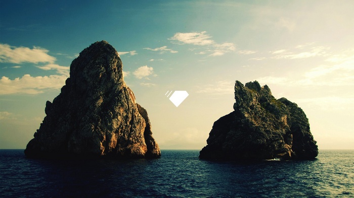 Two rocky islands in the sea under a cloudy sky