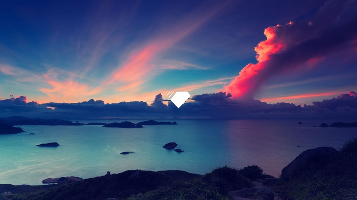 Islands in the ocean at sunset with colorful clouds