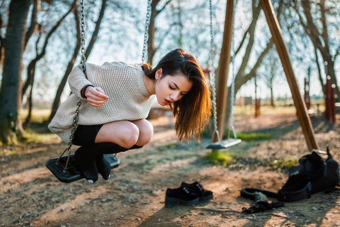 Woman on a swing in a park