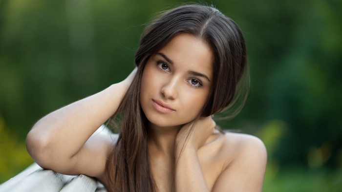 Young woman with bare shoulders outdoors
