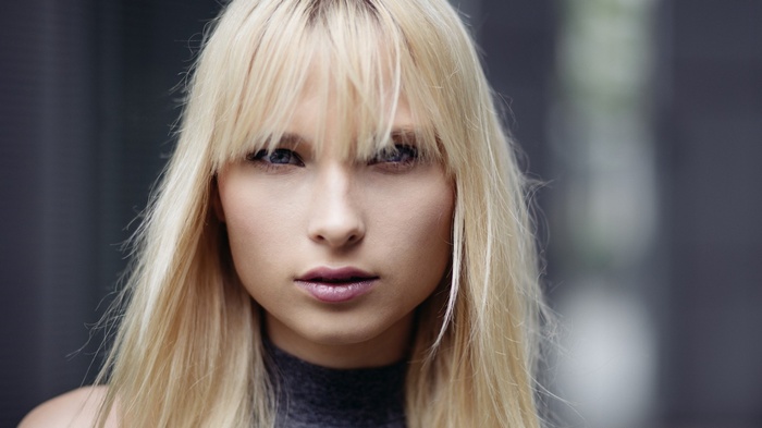 Portrait of a blonde woman with bangs