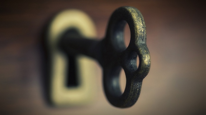 Close-up of an antique key in a keyhole