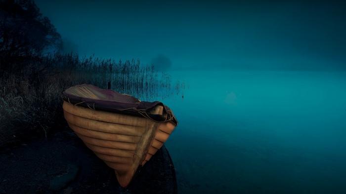 A boat on a misty lake at dusk