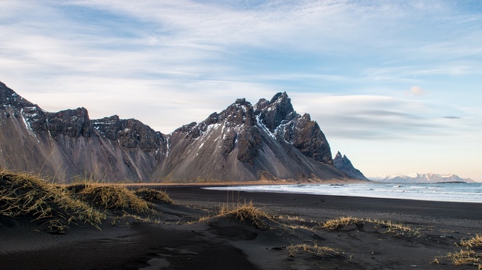 Black sand beach with jagged mountains in Iceland
