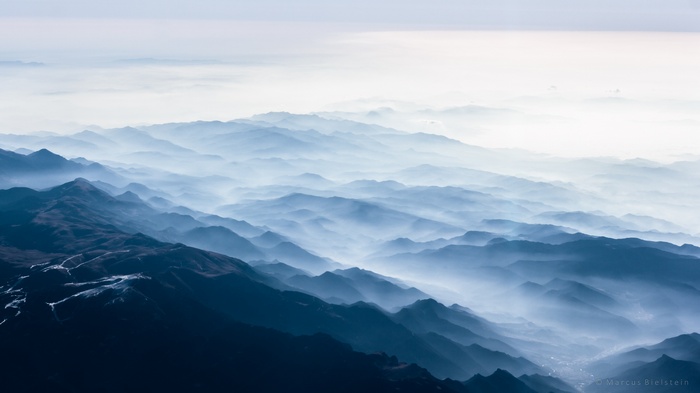 Misty mountains landscape with layers of blue haze