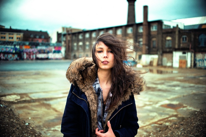 Woman in a fur-lined coat in an urban setting