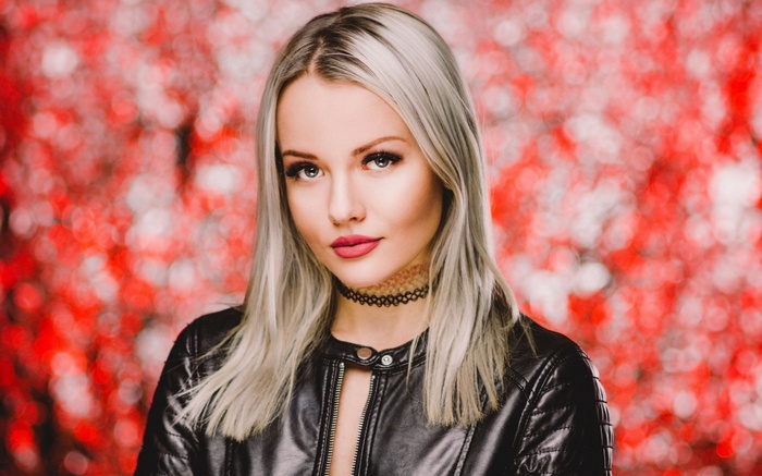 Woman with blonde hair wearing a black leather jacket