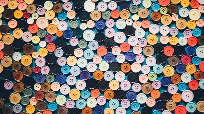 A collection of colorful buttons arranged on a blue surface