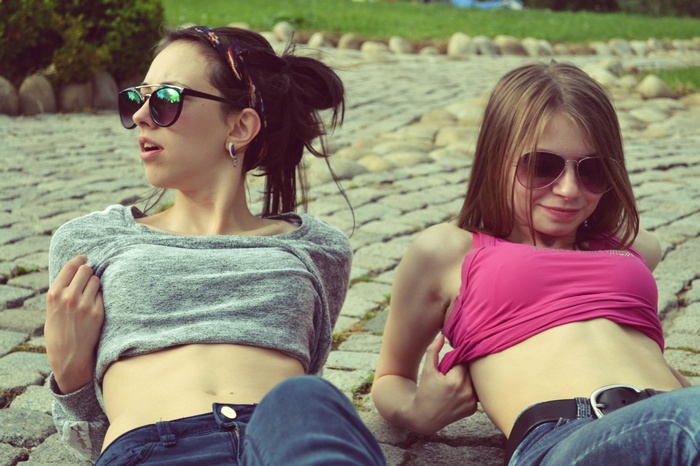 Two young women wearing sunglasses outdoors