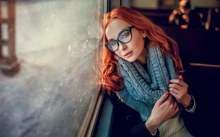Redhead woman with glasses wearing a scarf