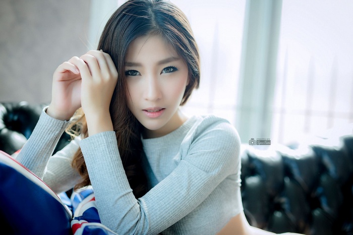 Asian model Atita Wittayakajohndet posing on a couch