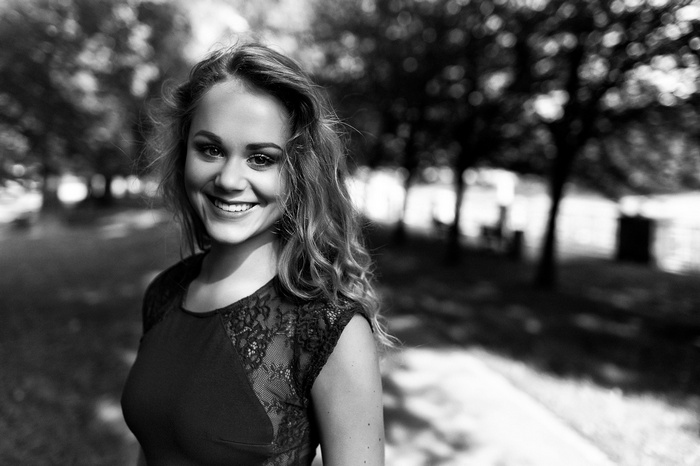 Woman with long hair smiling outdoors
