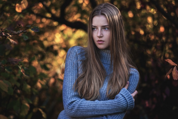 Maryana Ro in a blue sweater outdoors