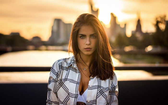 Woman in Plaid Shirt Outdoors with Cityscape