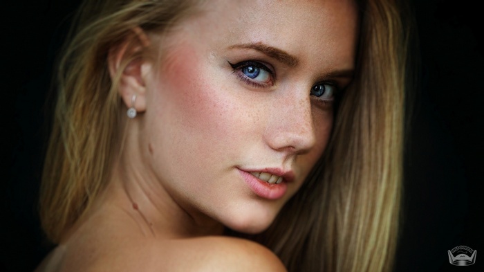 Portrait of a young woman with blonde hair and blue eyes