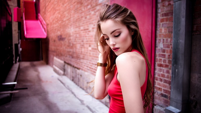 Woman in red tank top in alleyway