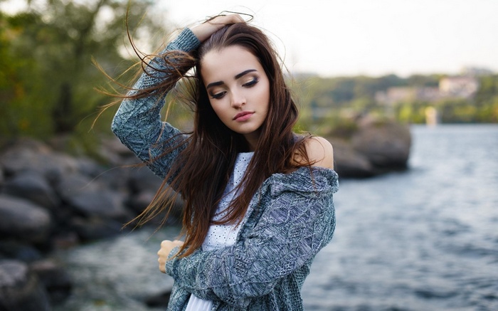 Woman in a sweater by the water
