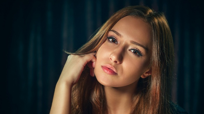 Woman with hand on face