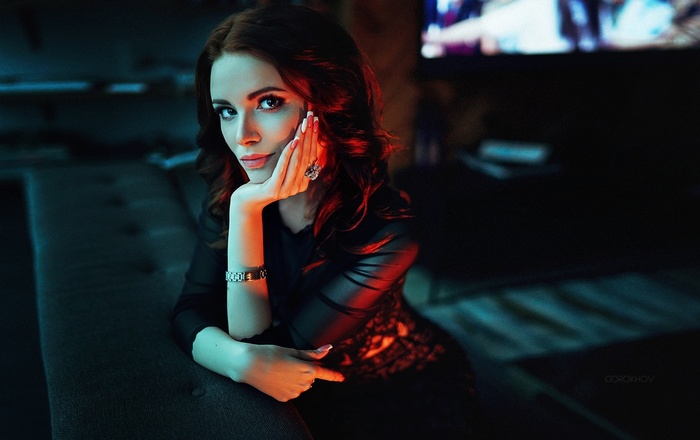 Woman with auburn hair in a black dress