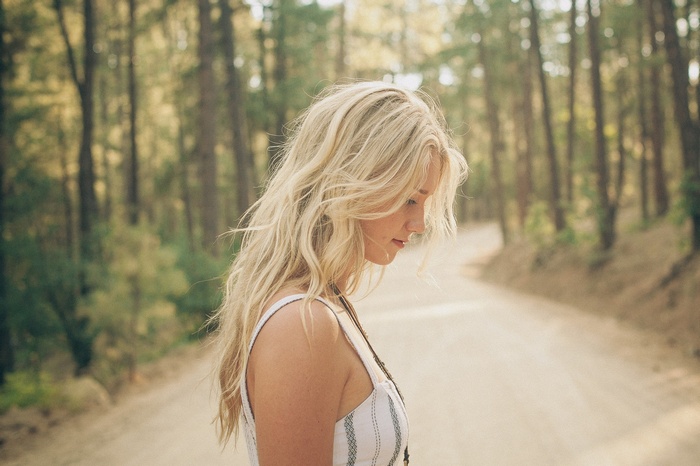 Woman with blonde hair in a forest
