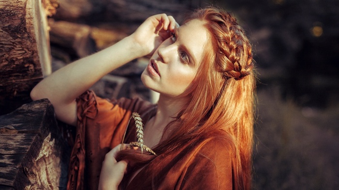 Woman with red hair and wheat stalk