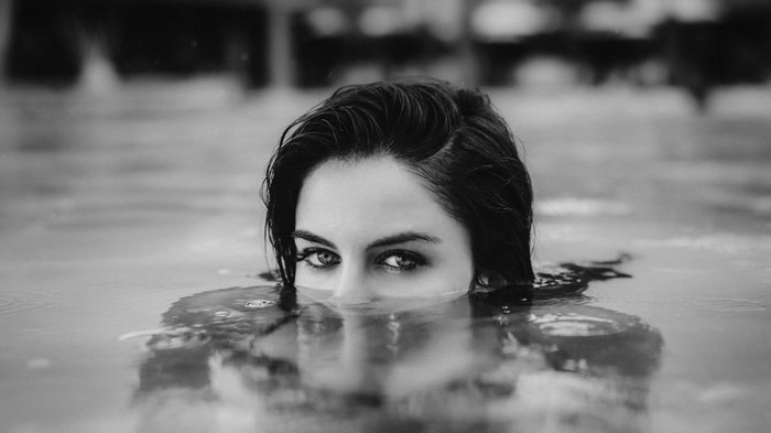 Monochrome portrait of a woman with wet hair in water