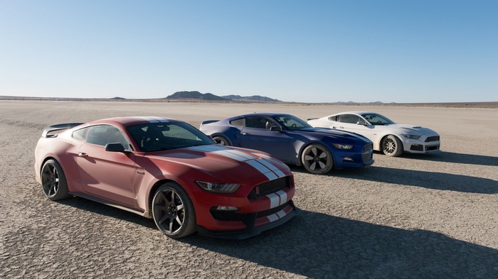 Three Ford Mustang GT350R cars on a dry lake bed