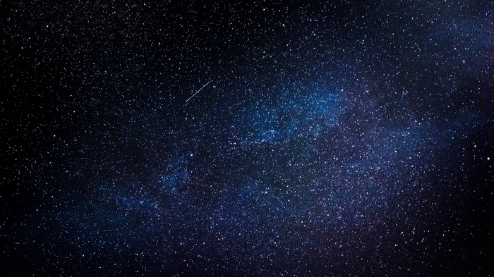 Starry night sky with a shooting star