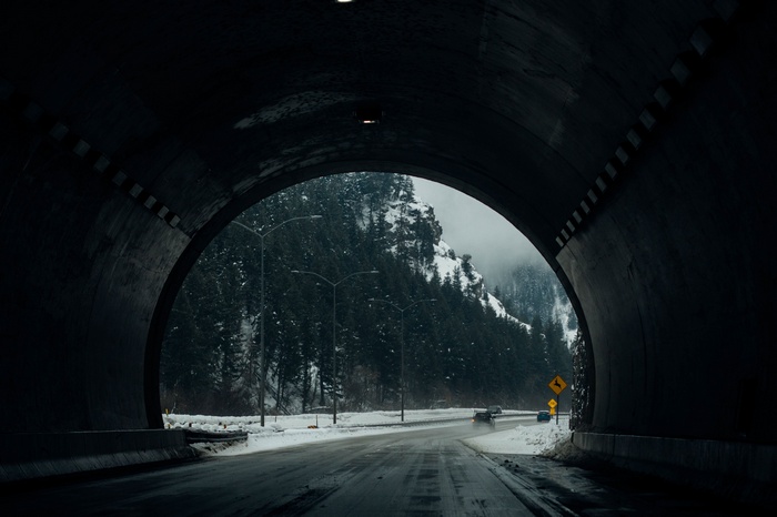Tunnel exit to snowy mountain road