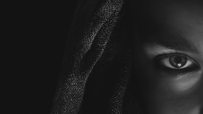 Close-up of a person's eye and textured fabric