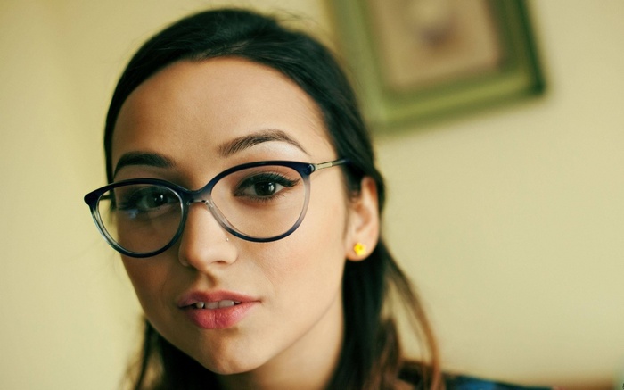 Woman with glasses and yellow earring