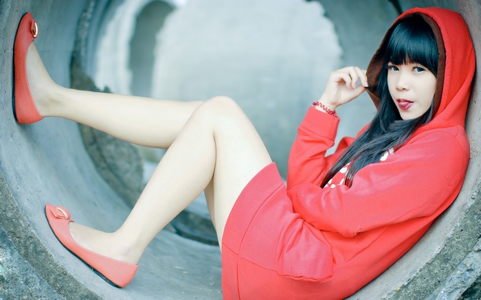 Woman in red hoodie sticking tongue out