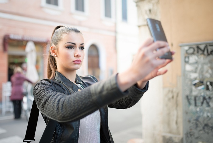 Woman taking a selfie outdoors
