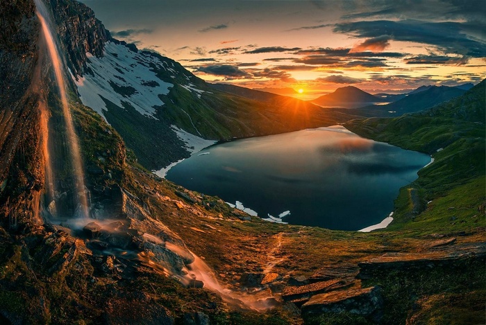 Waterfall and lake in Norway at sunrise