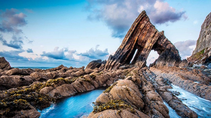 Blackchurch Rock archway on a rocky coastline