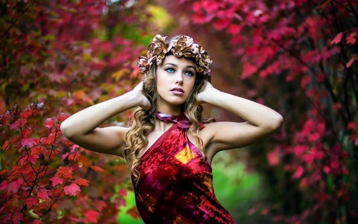 Woman with flower crown in autumn forest