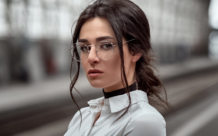 Woman with glasses wearing a white shirt