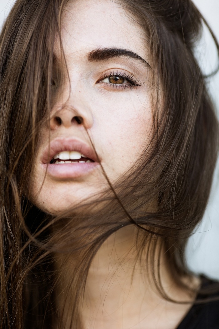 Woman with long brown hair and open mouth