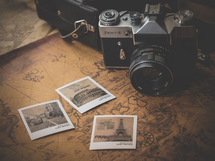 Zenit-E camera on a vintage map with postcards