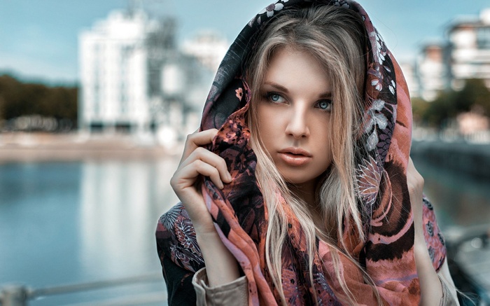 Woman with blonde hair wearing a patterned scarf