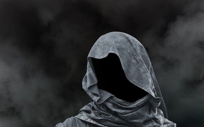 A hooded figure with a black void for a face