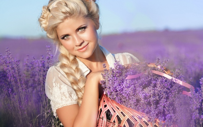 Woman with blonde braided hair holding a basket of lavender flowers