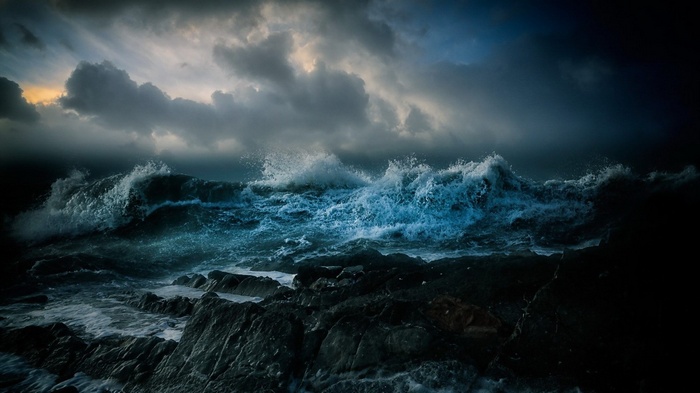 Stormy sea with waves crashing on rocks