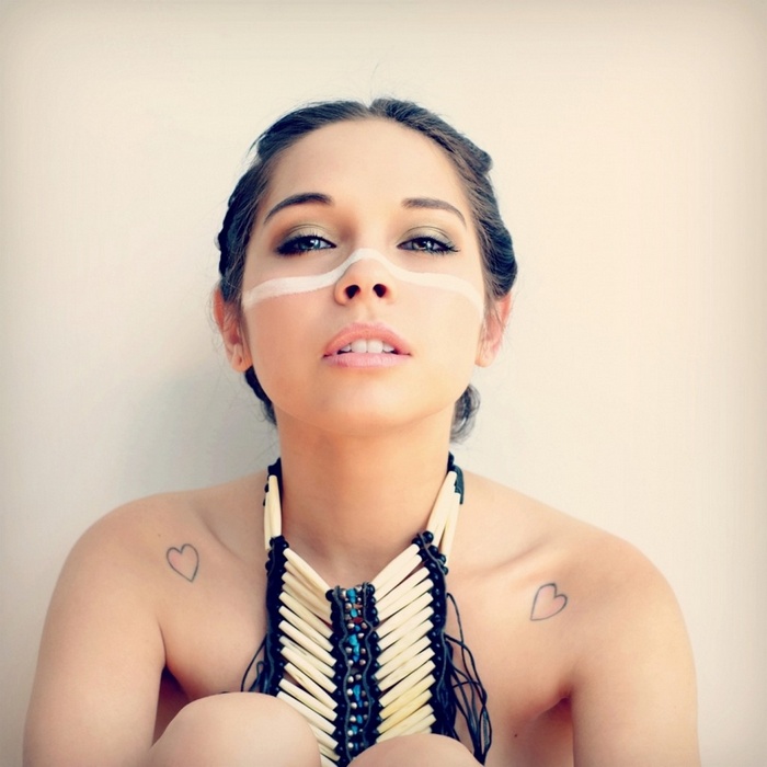 Woman with face paint and bone necklace