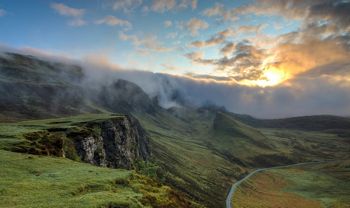 Misty mountains with sunlight and clouds