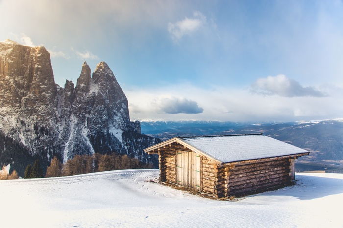Wooden cabin in snowy mountains