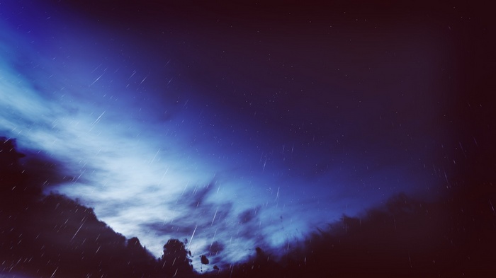 Rainy night sky with clouds and stars