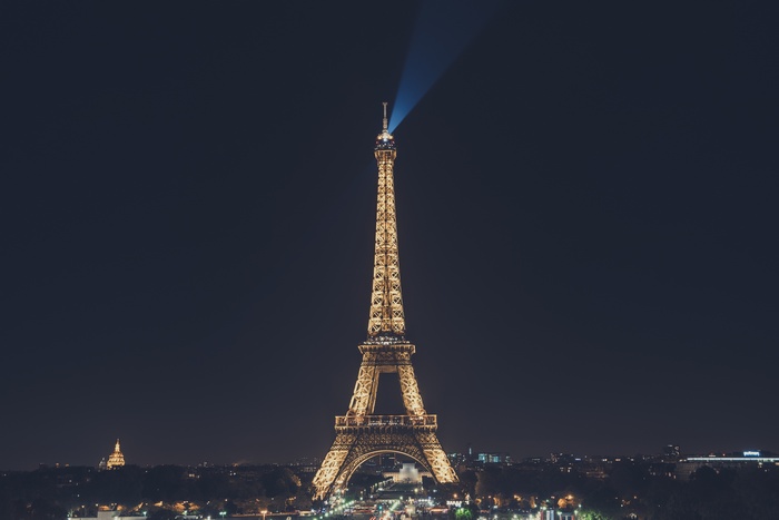 Eiffel Tower at night with a light beam