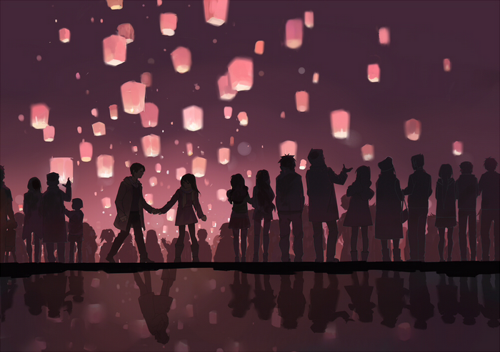 People releasing sky lanterns at night