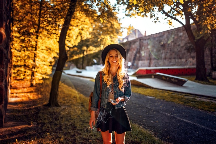Woman with blonde hair smoking a cigarette outdoors